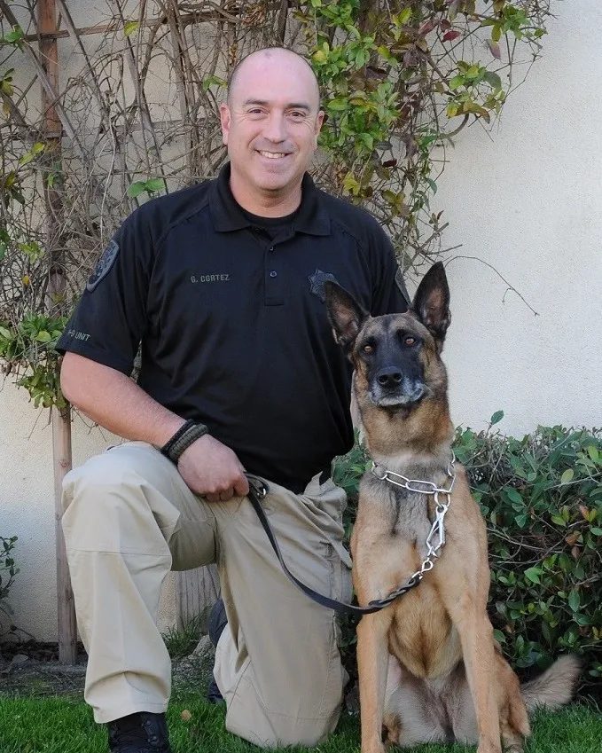 Portrait of Sergeant Gilbert Cortez and K9 Mattie